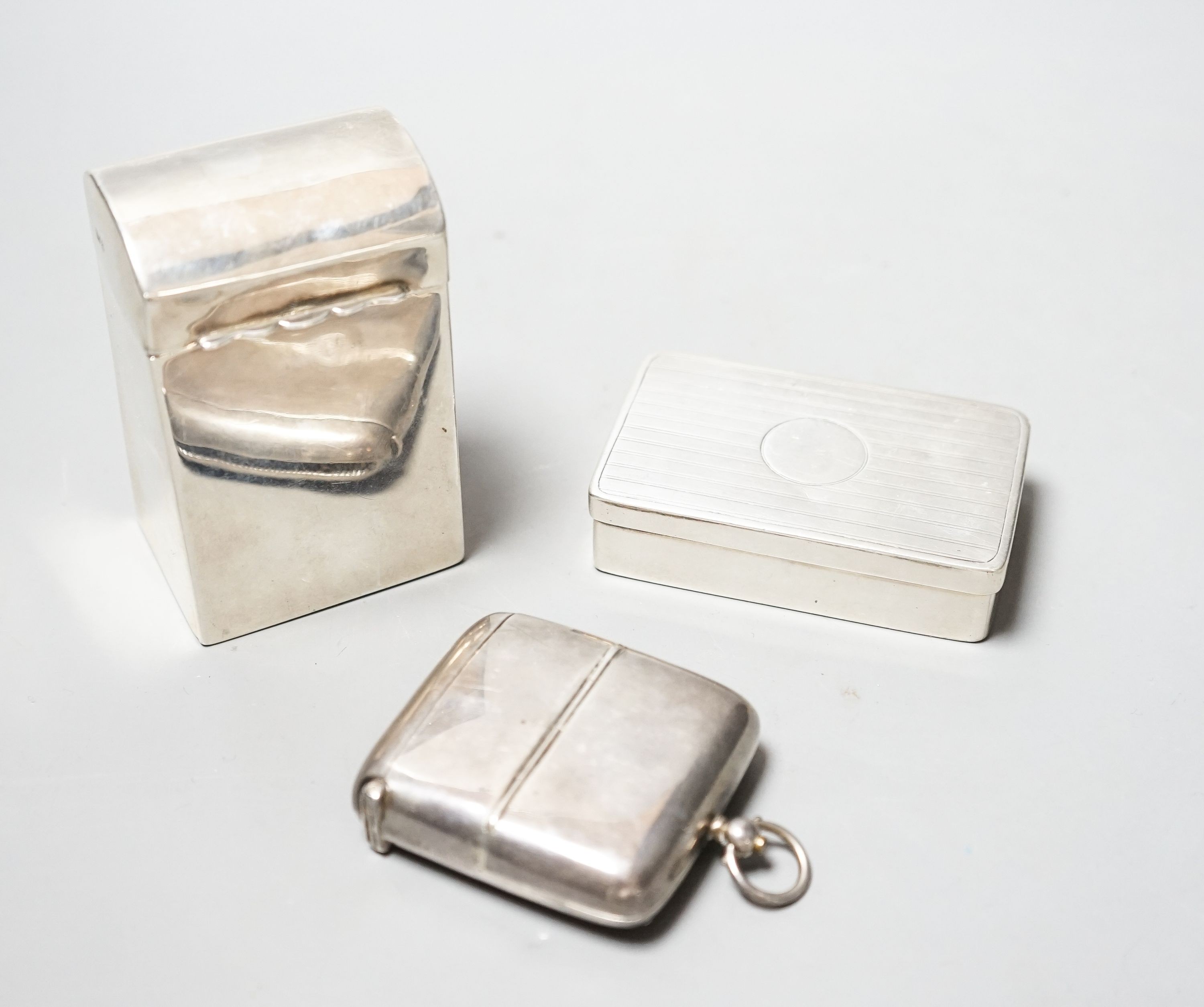 A late Victorian silver playing card box, Chester, 1900, 85mm, a similar snuff and a silver combination vesta case and sovereign/half sovereign case.